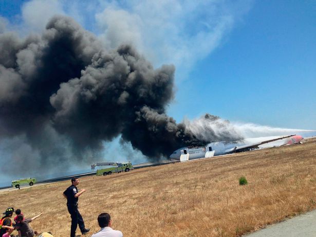 1 Asiana Airlines Boeing 777 is engulfed in smoke on the tarmac after crash landing at San Francisco I La maldición de los 7 La supuesta historia detrás del primer accidente fatal del Boeing 777