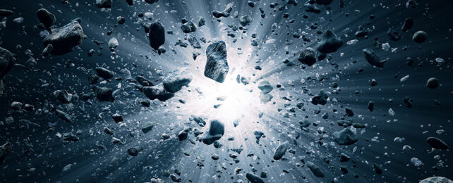 Explosión en el espacio rodeada de pequeñas rocas.